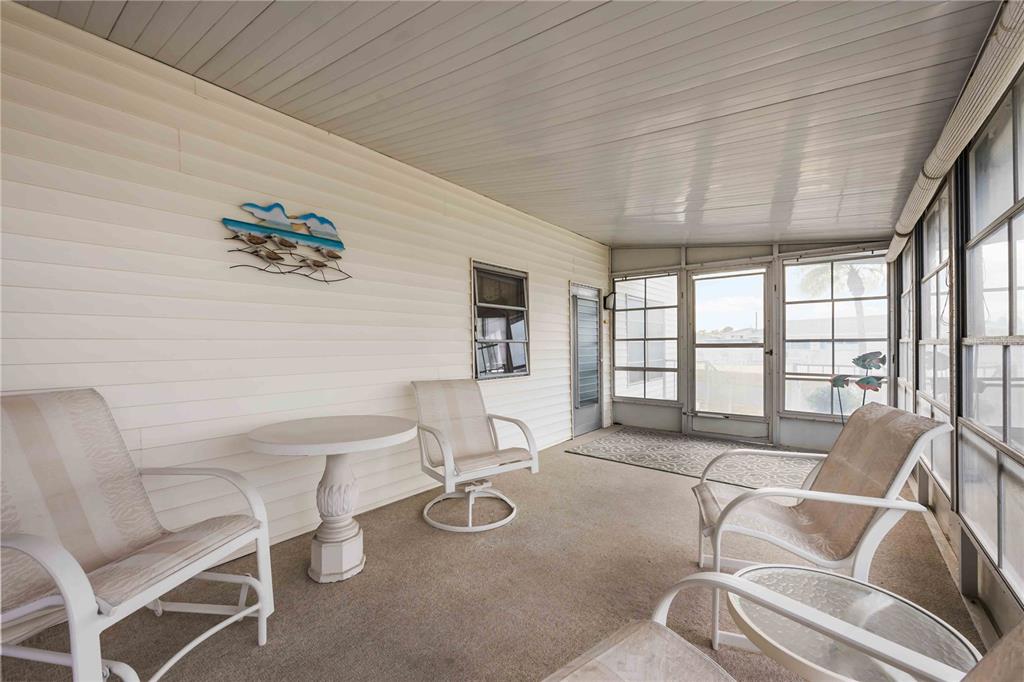 239 Inner Drive East Venice, FL 34285 - Photo 33 of 48 a living room with furniture and a floor to ceiling window