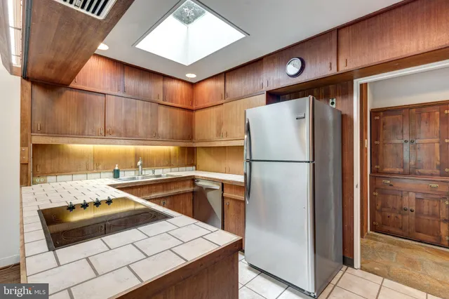 a kitchen with a sink and a refrigerator