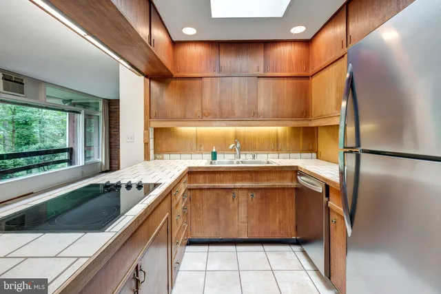 a view of a closet area with wooden floor
