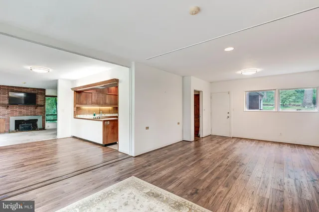 a room with a wooden floor and a window