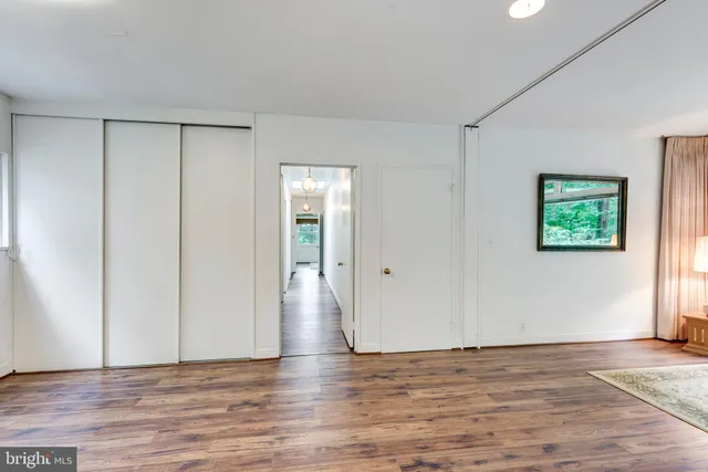 a view of room with window and wooden floor