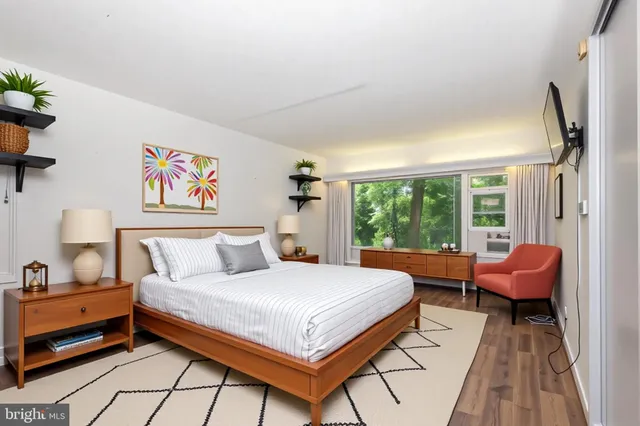 a view of a patio with table and chairs potted plants and large tree