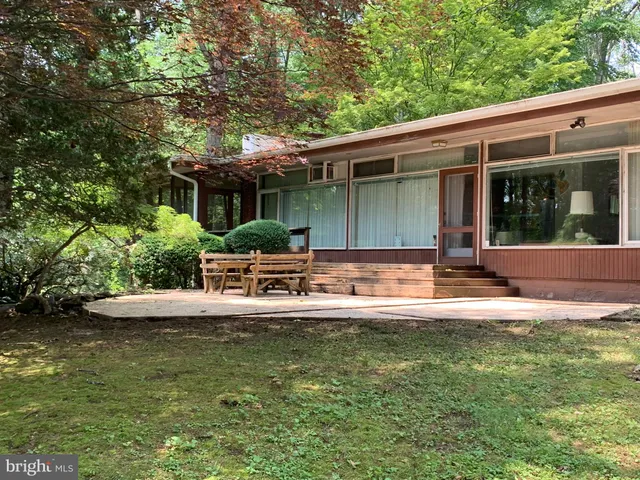 a view of a chair and tables in the back yard