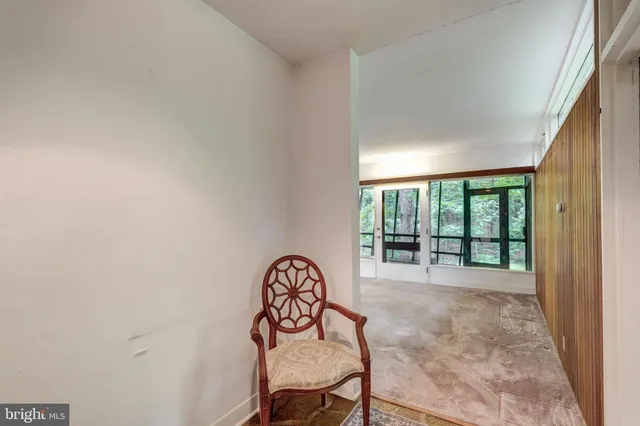 a view of an empty room with a fireplace and a large window