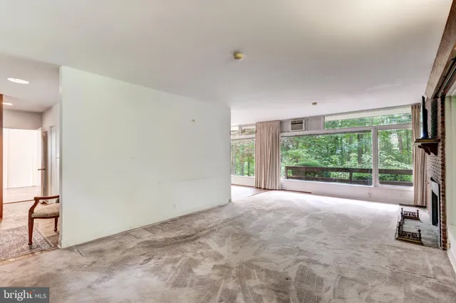 a view of an empty room with a fireplace