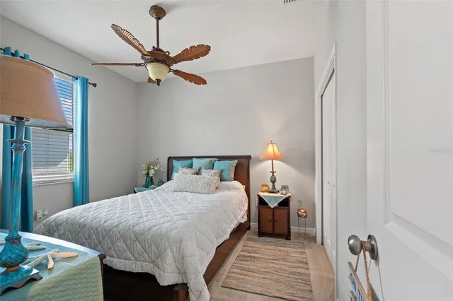 a bedroom with a large bed and a chandelier