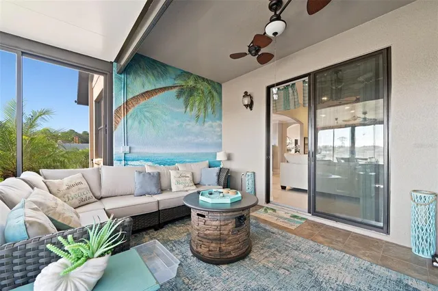a dining room with furniture and a large window