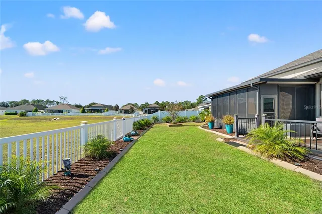 a view of a house with backyard and garden