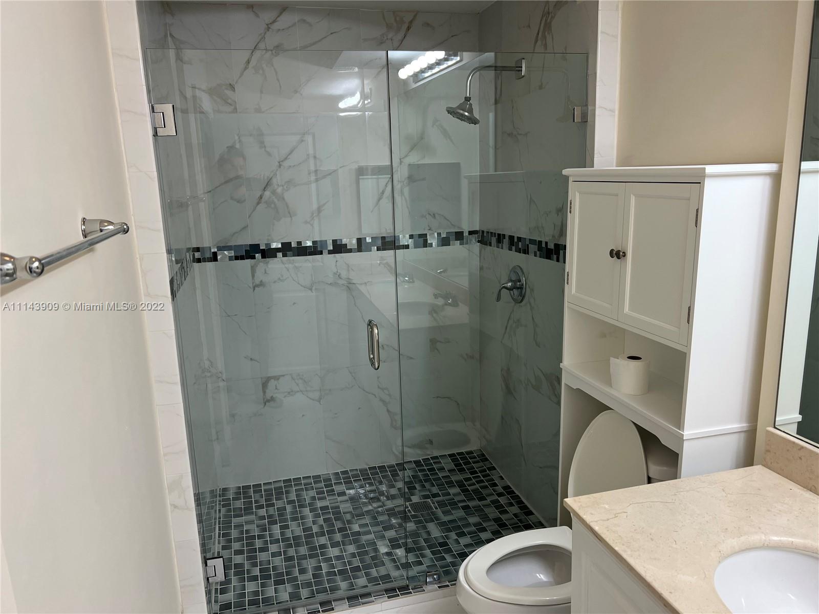 Renaissance Commons Boynton Beach, FL 33426 - Photo 5 of 10 a bathroom with a granite countertop shower and toilet