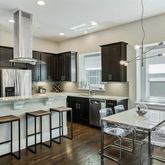 a kitchen with stainless steel appliances granite countertop a stove refrigerator and cabinets