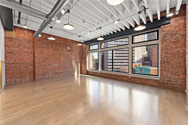 a view of an empty room with wooden floor