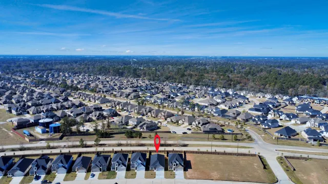 a large kitchen with kitchen island a sink a center island stainless steel appliances and a window