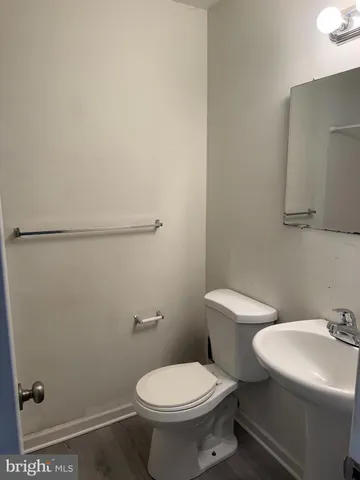 a white toilet sitting next to a bathroom sink