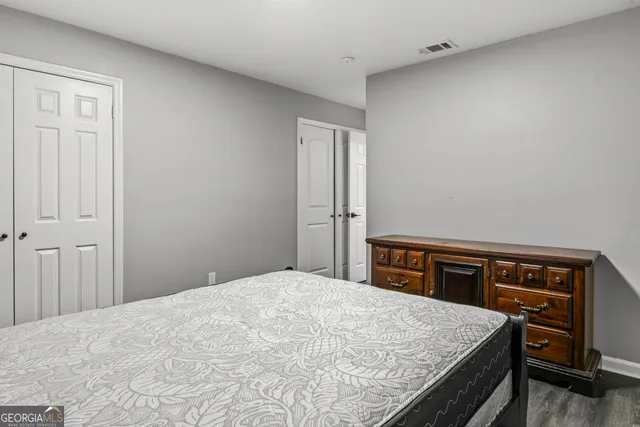 a kitchen with stainless steel appliances granite countertop hardwood floor sink stove dining table and chairs