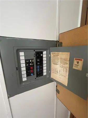 a view of a hallway with wooden floor and windows