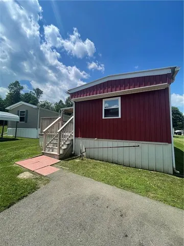a view of a backyard with wooden fence
