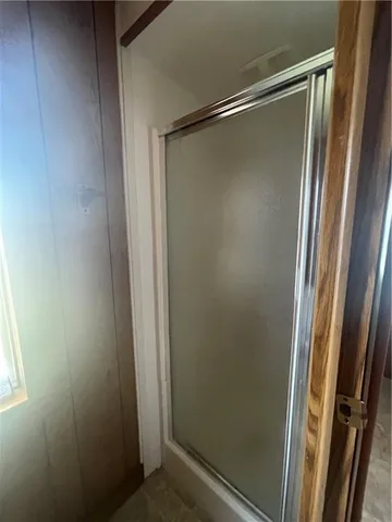 a bathroom with a glass shower door