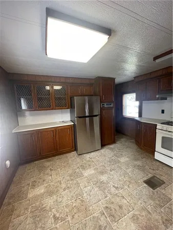 a large kitchen with a stove and a refrigerator