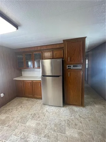 a kitchen with a refrigerator and a refrigerator