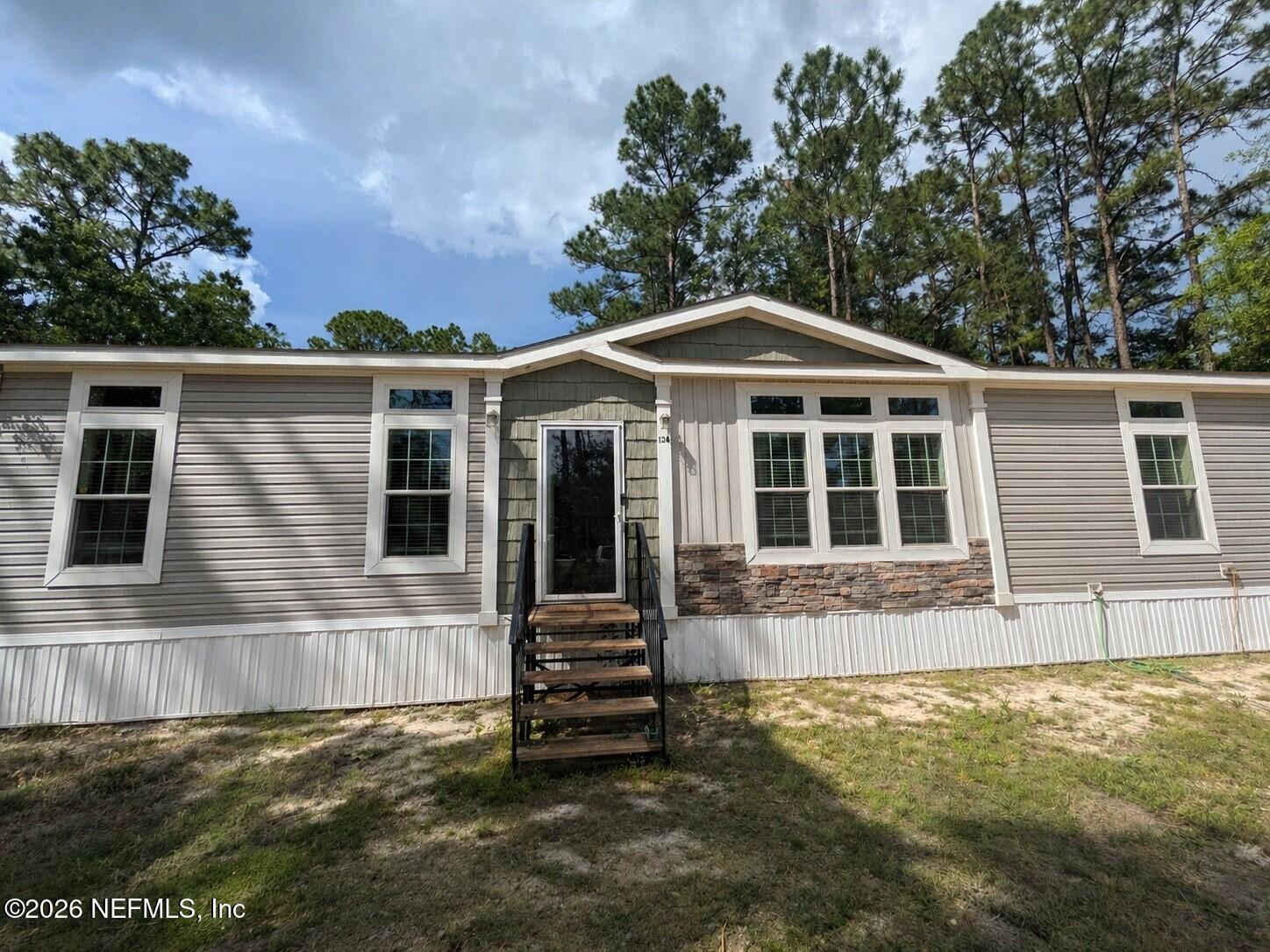 124 Jack Road Palatka, FL 32177 - Photo 1 of 18 a front view of a house with a yard