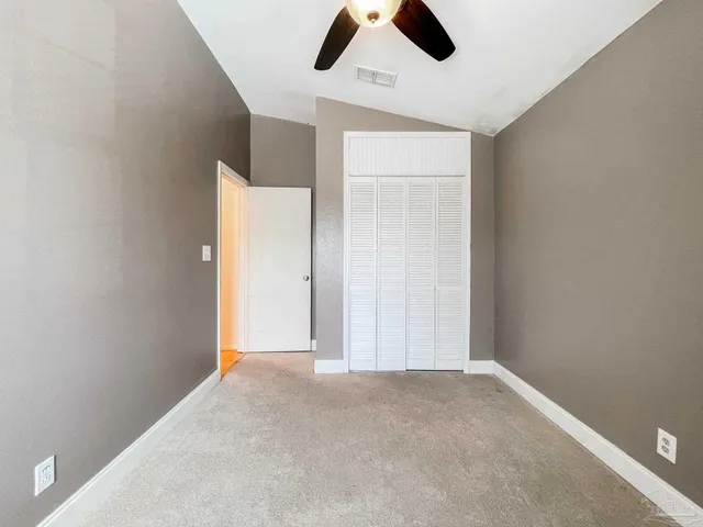 an empty room with ceiling fan