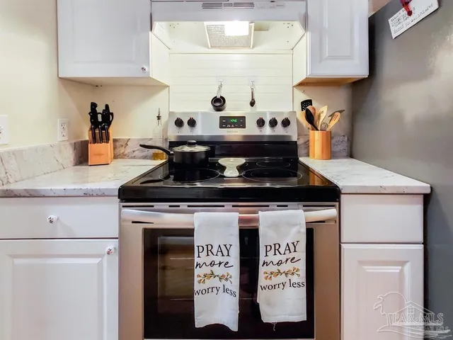 a kitchen with a stove and cabinets