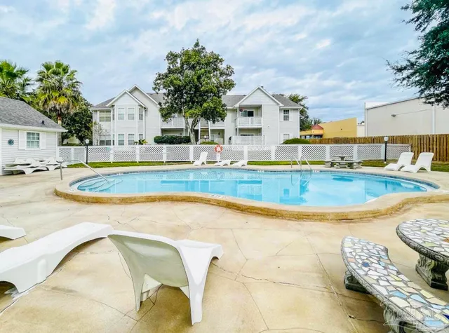 a view of pool with outdoor seating