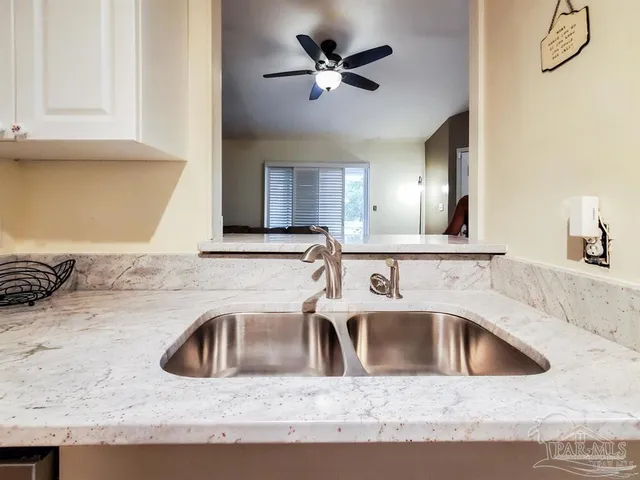 a kitchen with a sink a stove and a microwave