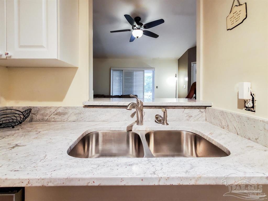 601 East Burgess Road, Unit E4 Pensacola, FL 32504 - Photo 8 of 18 a kitchen with a sink a stove and a microwave