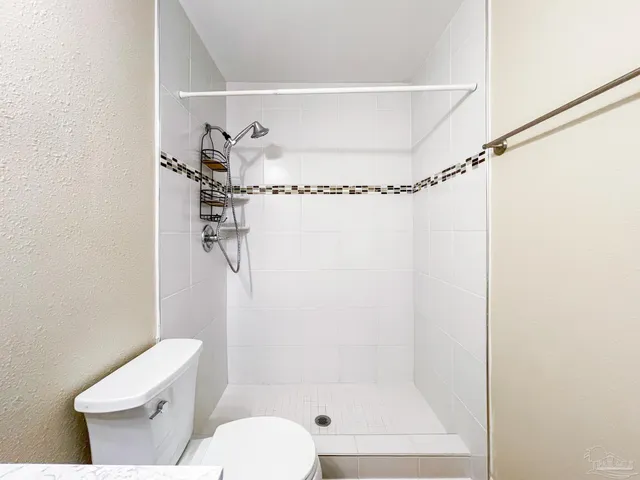 a bathroom with a toilet and shower
