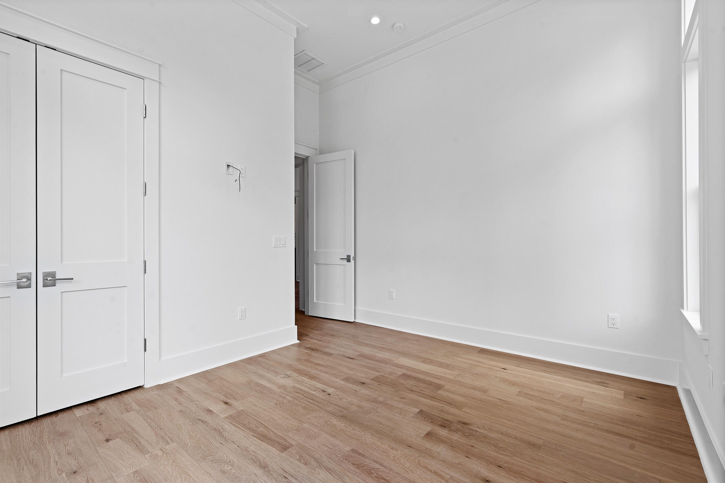 129 Pollard Cove West, Unit LOT 58 Watersound, FL 32461 - Photo 18 of 39 a view of an empty room with wooden floor