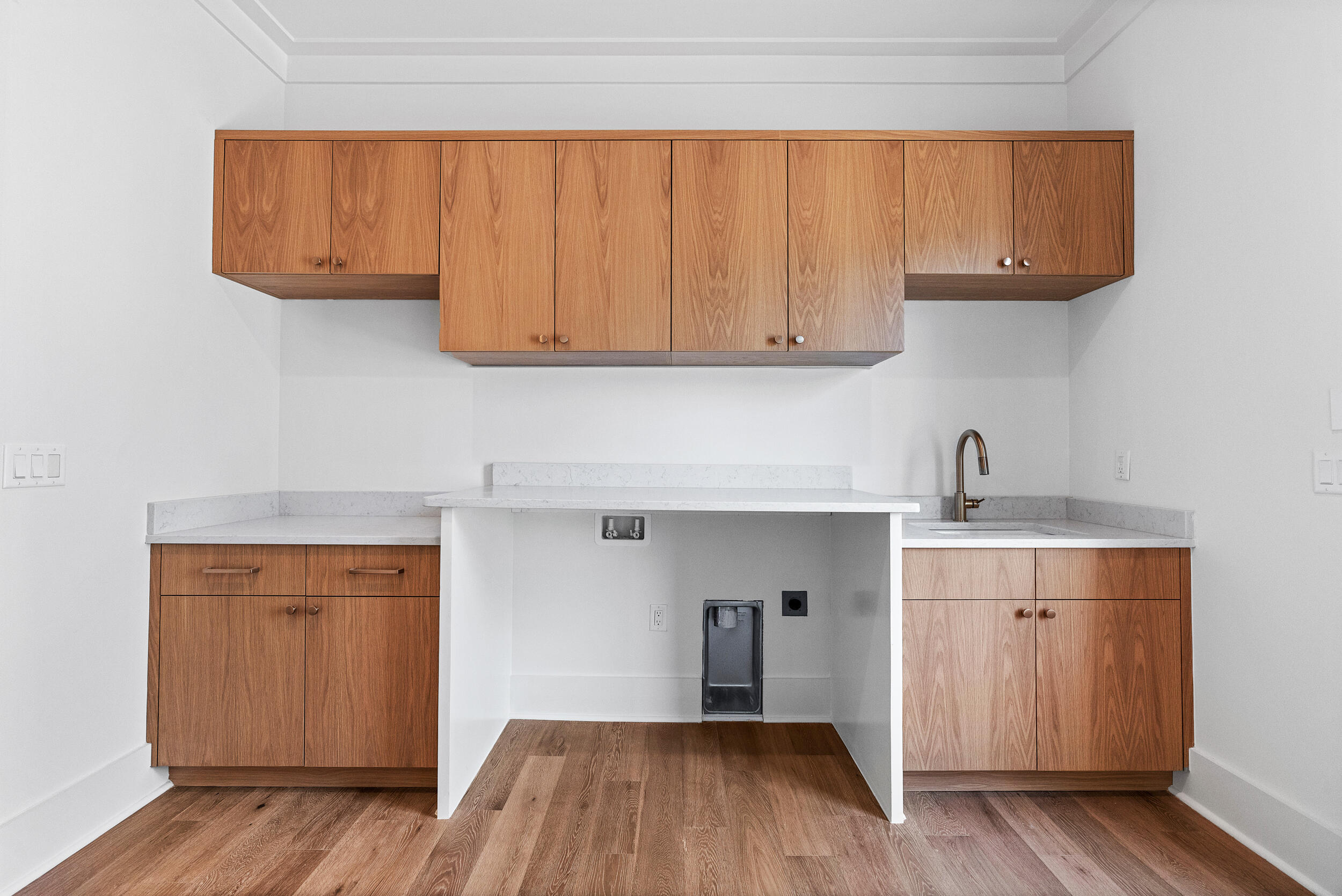 129 Pollard Cove West, Unit LOT 58 Watersound, FL 32461 - Photo 19 of 39 a kitchen with wooden cabinets and a sink