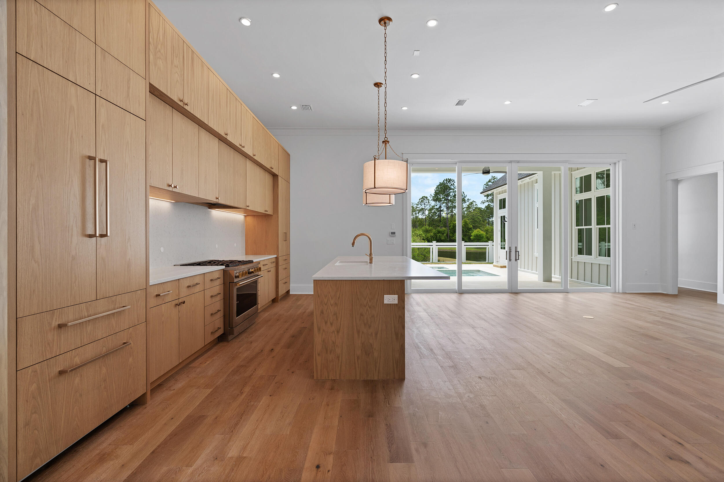 129 Pollard Cove West, Unit LOT 58 Watersound, FL 32461 - Photo 3 of 39 a large kitchen with cabinets wooden floor and a window