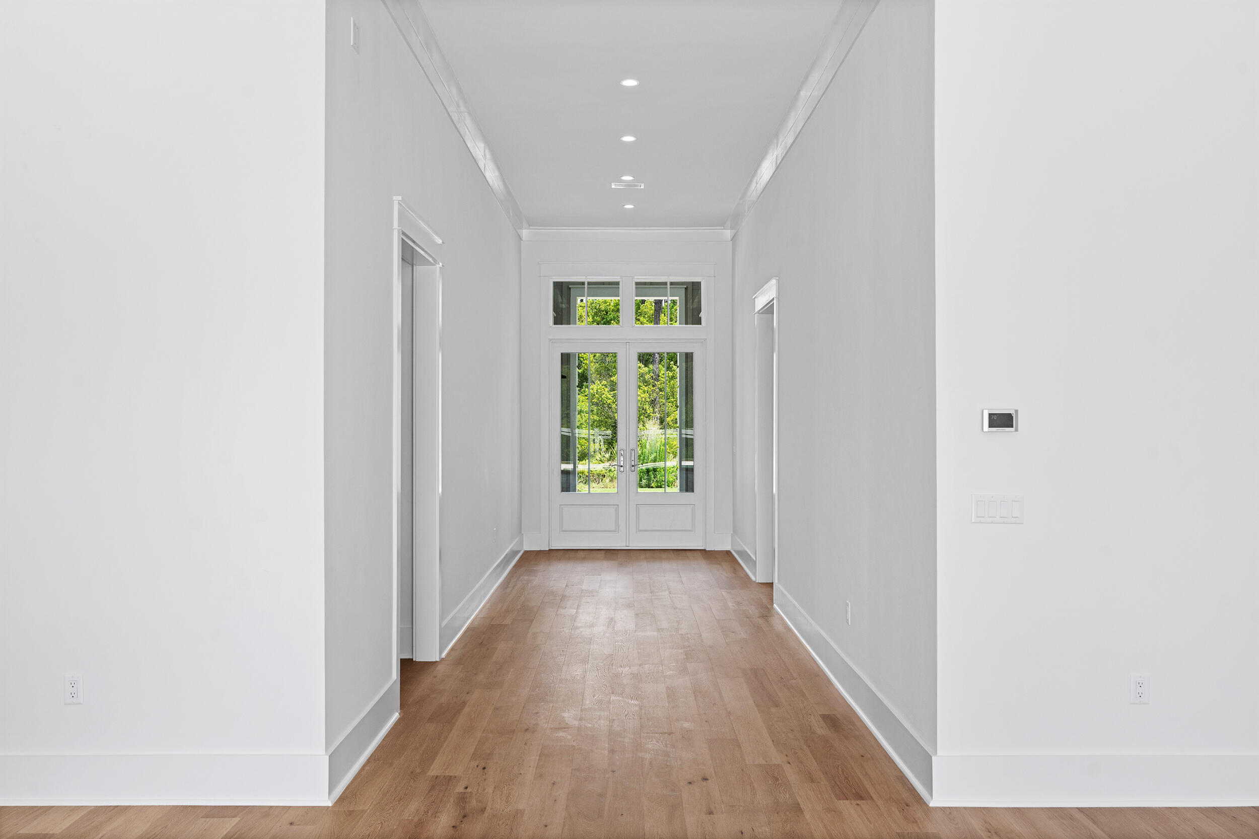 129 Pollard Cove West, Unit LOT 58 Watersound, FL 32461 - Photo 7 of 39 a view of hallway with wooden floor