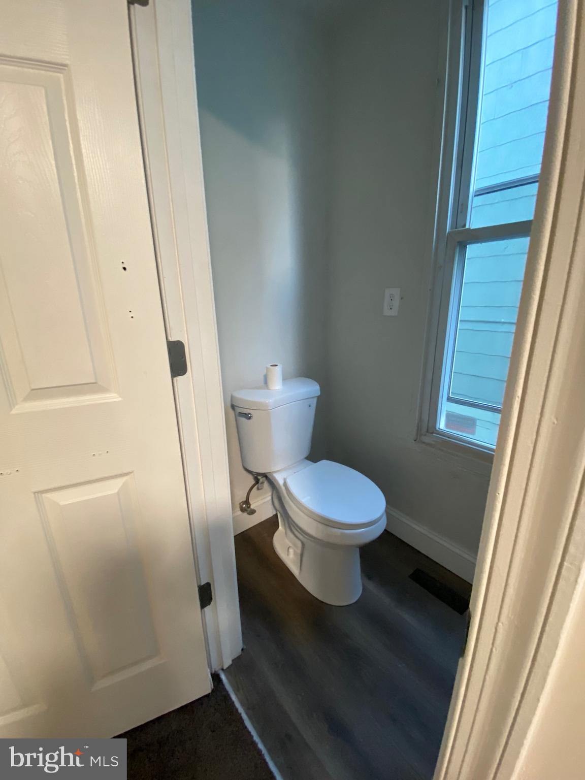 724 East 35th Street Baltimore, MD 21218 - Photo 11 of 13 a white toilet sitting next to a sink