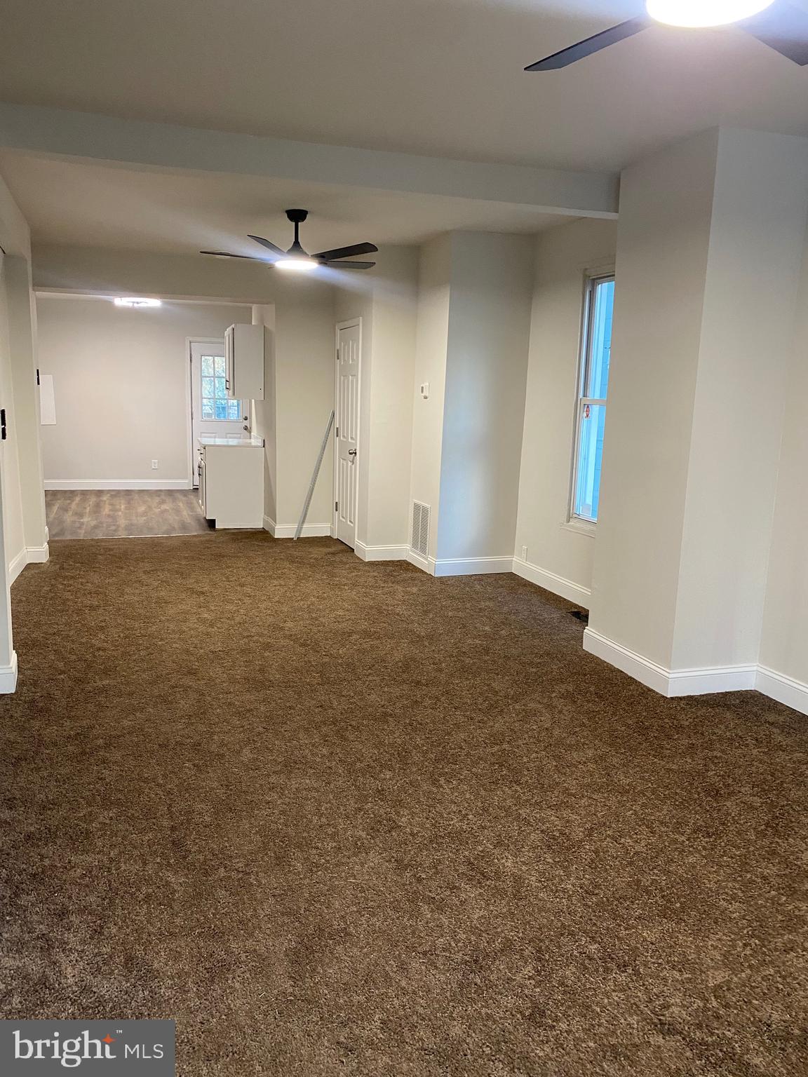 724 East 35th Street Baltimore, MD 21218 - Photo 5 of 13 an empty room with staircase and ceiling fan