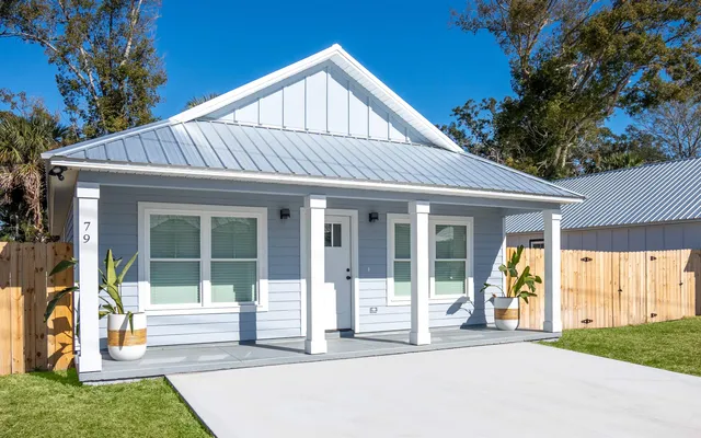 a front view of a house with a yard and porch