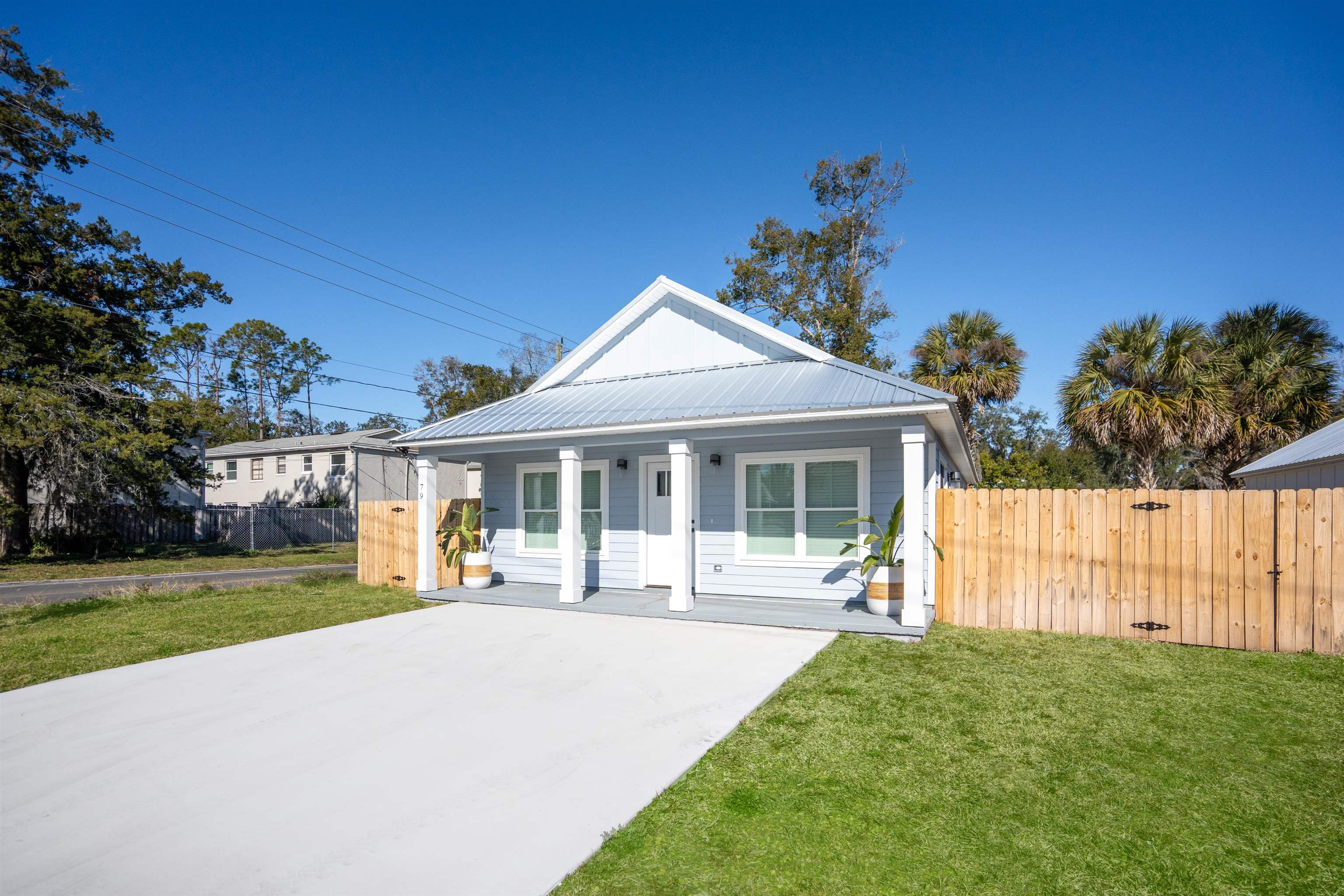 79 Helen Street St. Augustine, FL 32084 - Photo 2 of 33 a front view of a house with a garden and yard