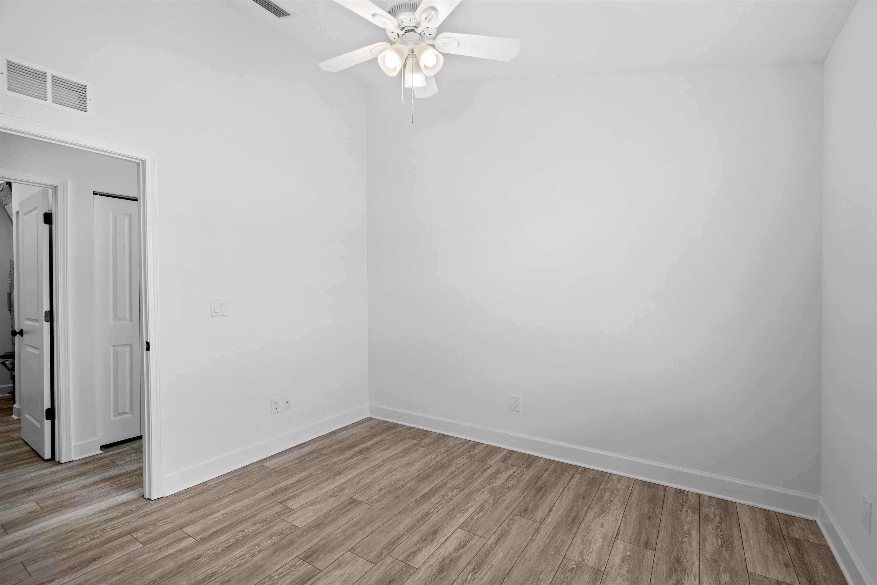 79 Helen Street St. Augustine, FL 32084 - Photo 23 of 33 an empty room with wooden floor and fan