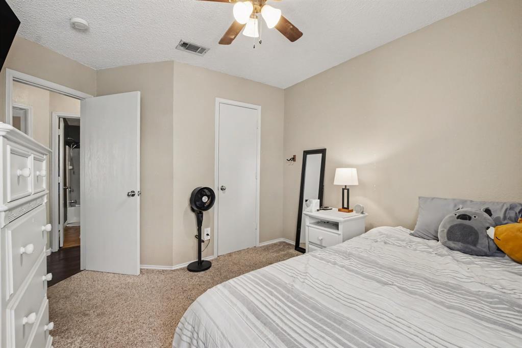 4932 Spur Ridge Court Fort Worth, TX 76244 - Photo 28 of 31 Carpeted bedroom with neutral wall tones