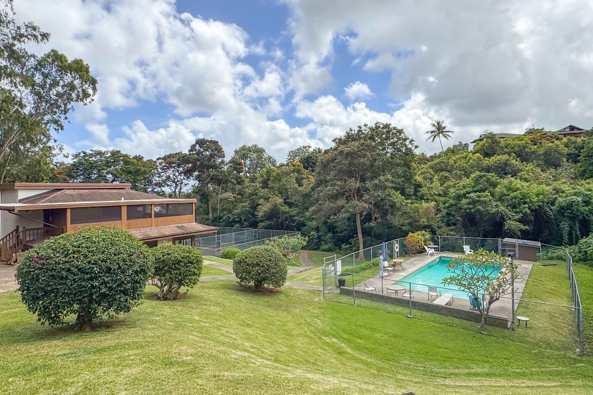 4701 Kawaihau Road, Unit C201 Kapaa, HI 96746 - Photo 18 of 28 a view of a house with a backyard porch and sitting area
