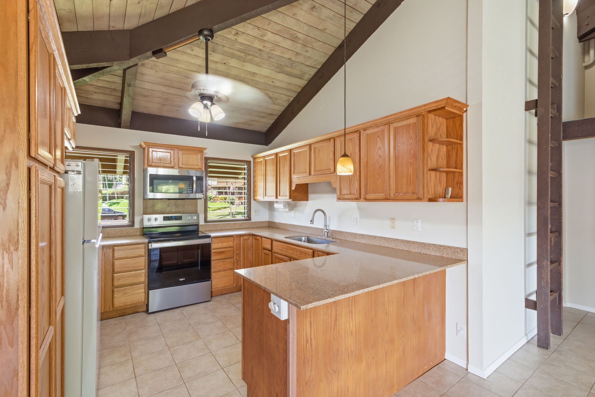 4701 Kawaihau Road, Unit C201 Kapaa, HI 96746 - Photo 7 of 28 a kitchen that has a sink and a stove