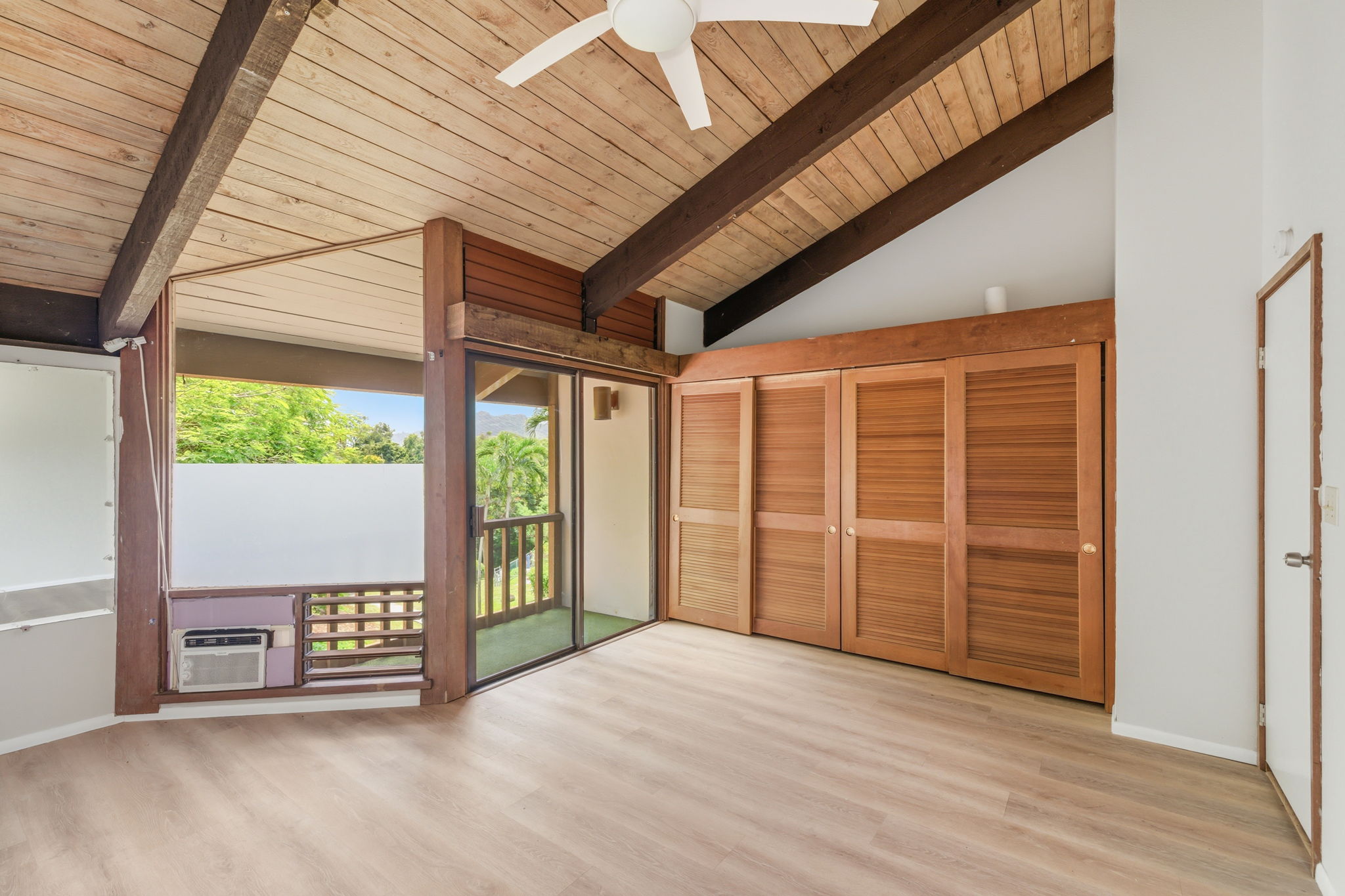 4701 Kawaihau Road, Unit C201 Kapaa, HI 96746 - Photo 9 of 28 a view of an empty room with wooden floor and doors