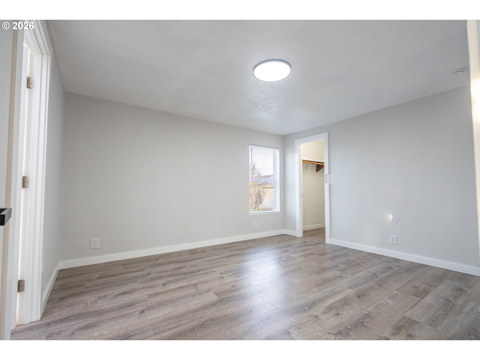 3554 Turner Road Southeast Salem, OR 97302 - Photo 13 of 20 a view of an empty room with wooden floor and a window