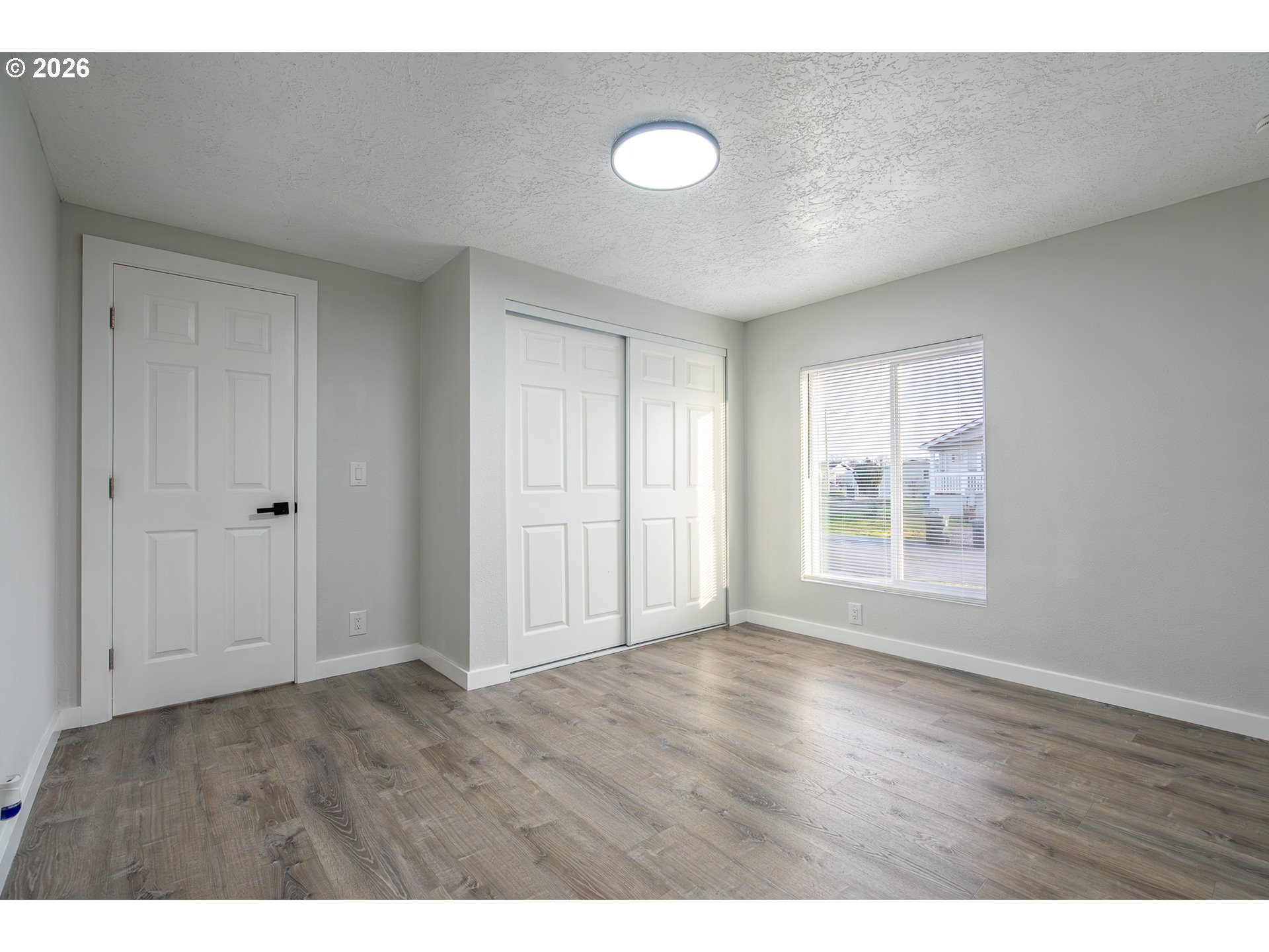 3554 Turner Road Southeast Salem, OR 97302 - Photo 16 of 20 a view of an empty room with wooden floor and a window