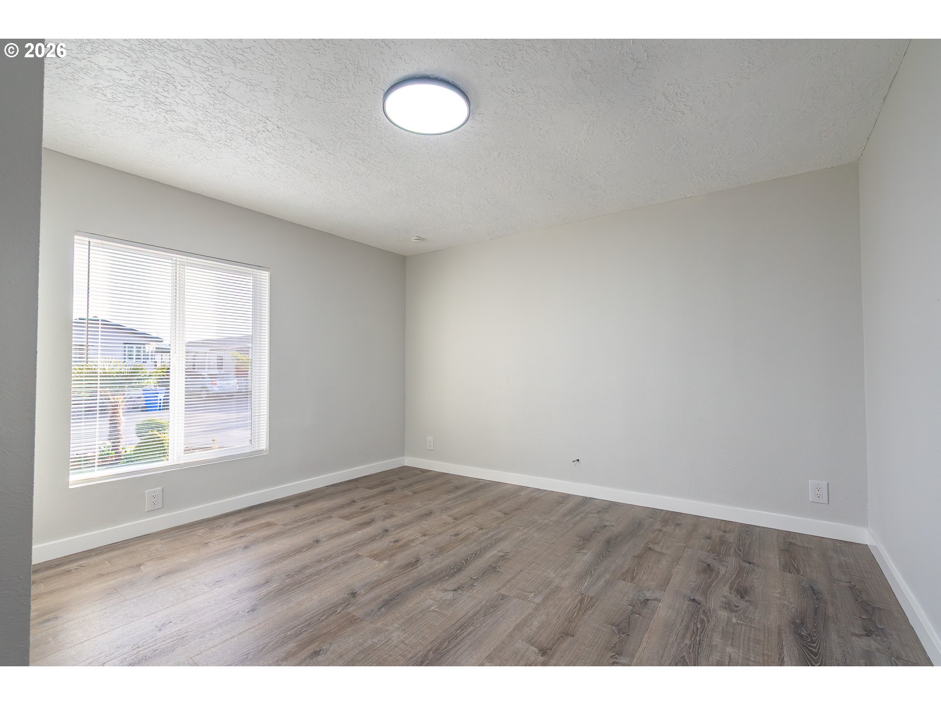 3554 Turner Road Southeast Salem, OR 97302 - Photo 19 of 20 a view of an empty room with wooden floor and a window