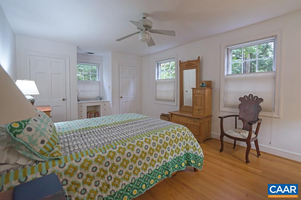 2040 Thomson Road Charlottesville, VA 22903 - Photo 11 of 23 a bedroom with a bed and a table in it with window