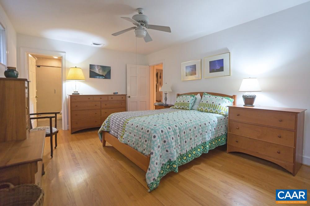 2040 Thomson Road Charlottesville, VA 22903 - Photo 12 of 23 a bedroom with a bed and wooden floor
