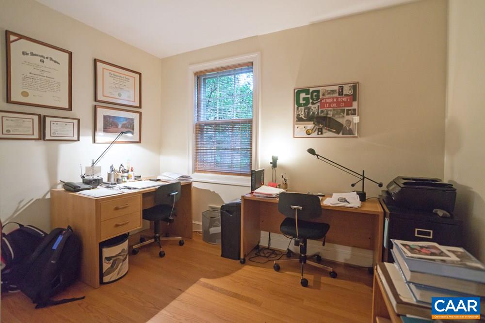 2040 Thomson Road Charlottesville, VA 22903 - Photo 16 of 23 a view of a workspace with furniture and a window