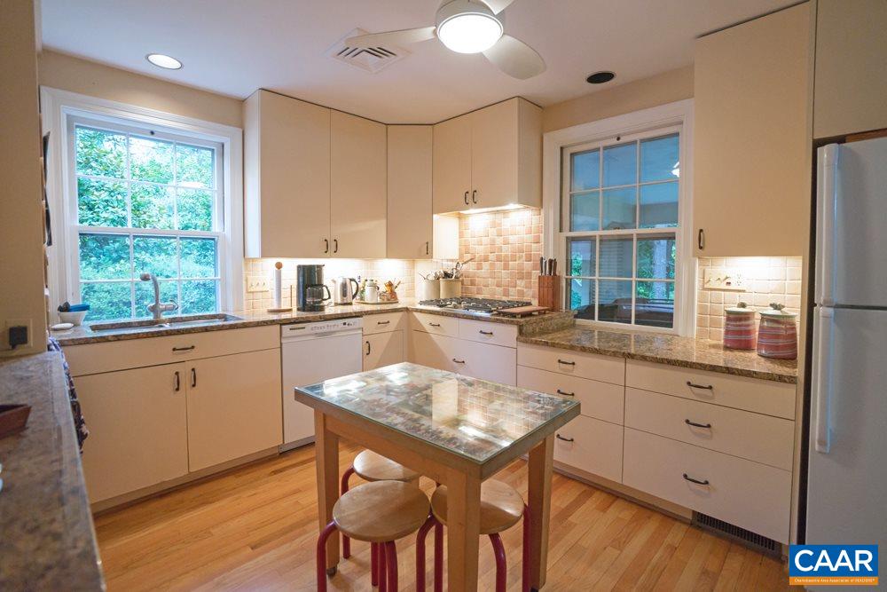 2040 Thomson Road Charlottesville, VA 22903 - Photo 9 of 23 a kitchen with a table chairs sink and cabinets